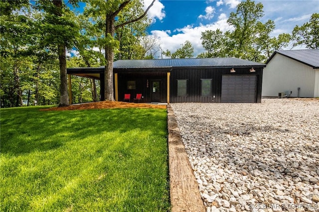view of outbuilding featuring an attached garage and gravel driveway