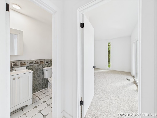 27294 Marina Ln, Barnett, MO 65011 - bathroom featuring tile walls, toilet, vanity, and a wainscoted wall