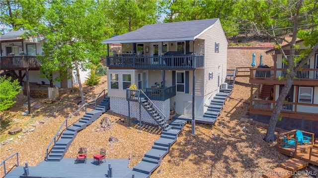 view of front of house with stairway and a balcony