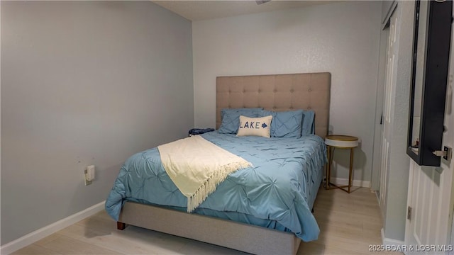 bedroom with wood finished floors and baseboards
