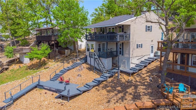 rear view of house featuring stairs, a deck, and central air condition unit