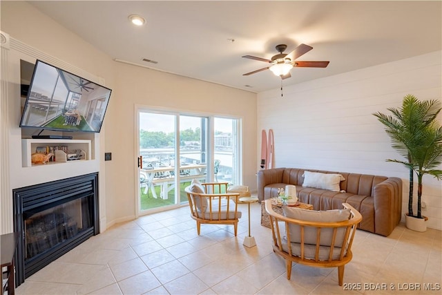 85 Monarch Cove Ln Unit 2C, Lake Ozark, MO 65049 - living area featuring a ceiling fan, a glass covered fireplace, light tile patterned flooring, and recessed lighting