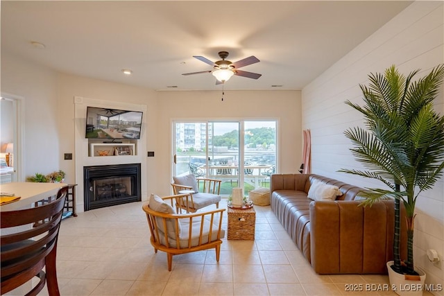 85 Monarch Cove Ln Unit 2C, Lake Ozark, MO 65049 - living room with a glass covered fireplace, a ceiling fan, and light tile patterned floors