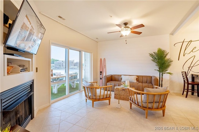 85 Monarch Cove Ln Unit 2C, Lake Ozark, MO 65049 - living room with a ceiling fan, light tile patterned floors, and a fireplace