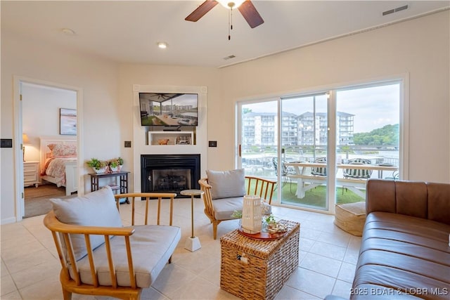 85 Monarch Cove Ln Unit 2C, Lake Ozark, MO 65049 - living room featuring ceiling fan, a glass covered fireplace, light tile patterned floors, and recessed lighting