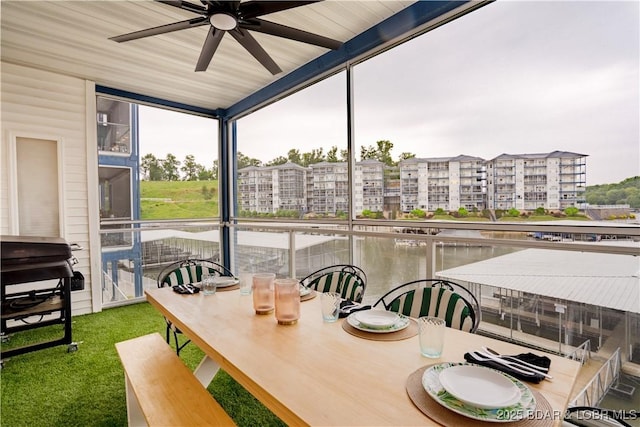 85 Monarch Cove Ln Unit 2C, Lake Ozark, MO 65049 - sunroom featuring a ceiling fan, outdoor dining area, and a water view