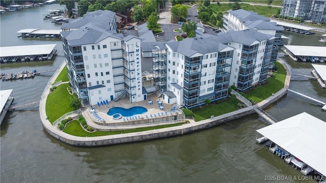 85 Monarch Cove Ln Unit 2C, Lake Ozark, MO 65049 - drone / aerial view of apartment complex / building, a nearby body of water, and a pool