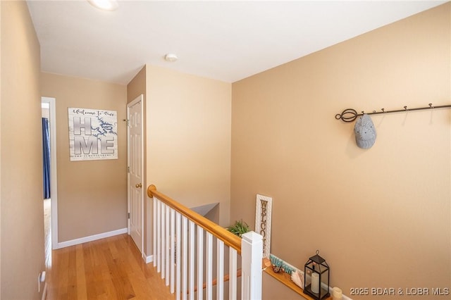 1104 Whippoorwill Ln, Sunrise Beach, MO 65079 - corridor featuring an upstairs landing, wood finished floors, and baseboards