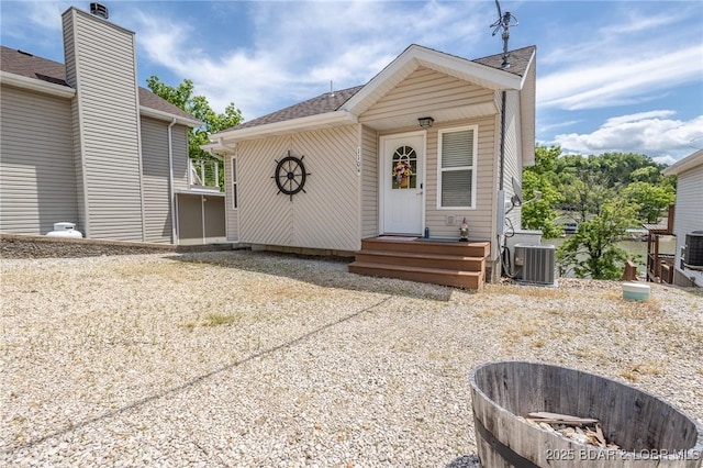 1104 Whippoorwill Ln, Sunrise Beach, MO 65079 - view of front of home with central AC unit and a shingled roof