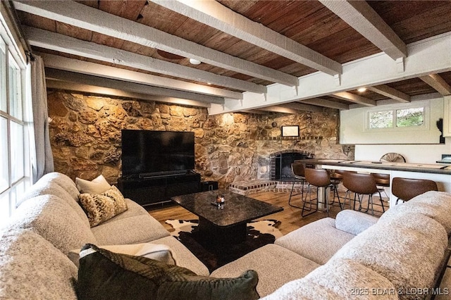 6076 Sioux Trl, Osage Beach, MO 65065 - living area with wood finished floors, a fireplace, beam ceiling, and wood ceiling