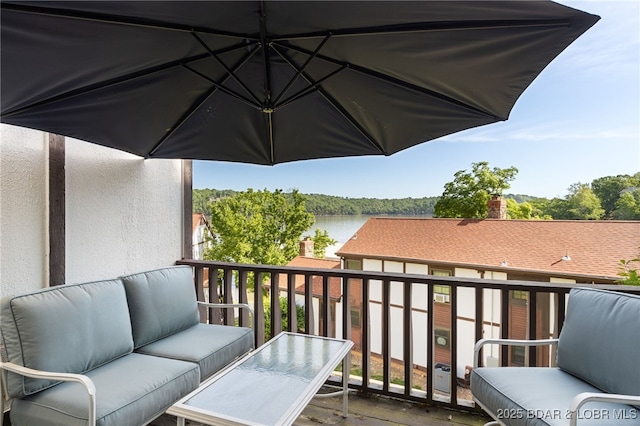 balcony with an outdoor hangout area and a water view