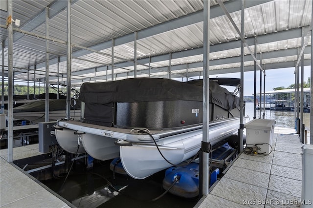 dock area featuring boat lift and a water view