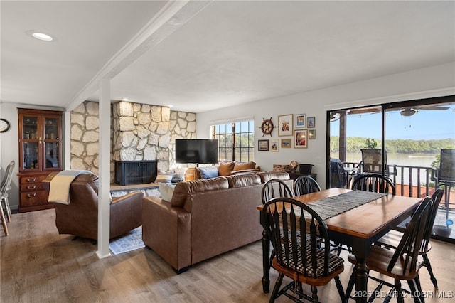 dining space with light wood-type flooring and a fireplace