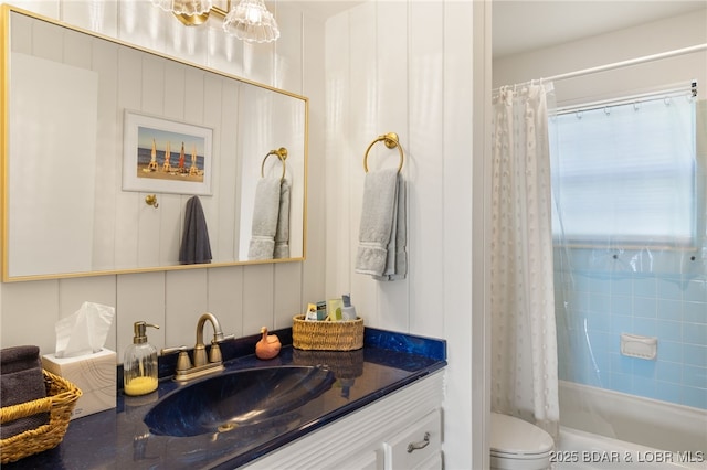 full bath with toilet, vanity, and shower / bath combo with shower curtain