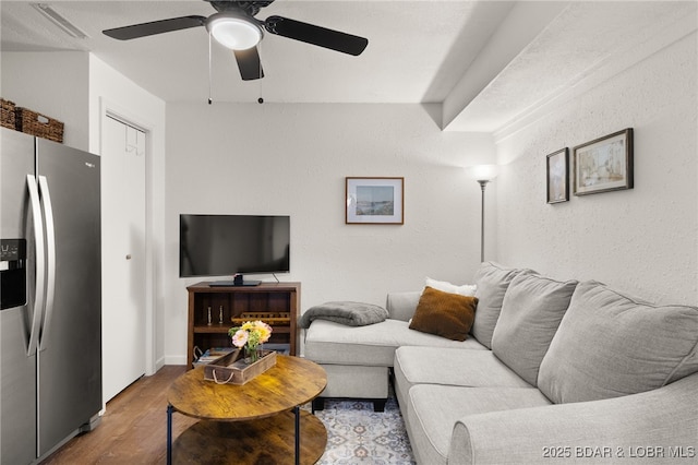 living room with wood finished floors and ceiling fan