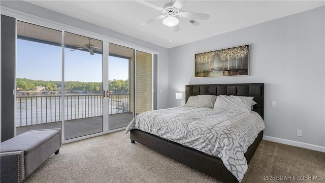 bedroom featuring access to exterior, baseboards, carpet, a water view, and ceiling fan