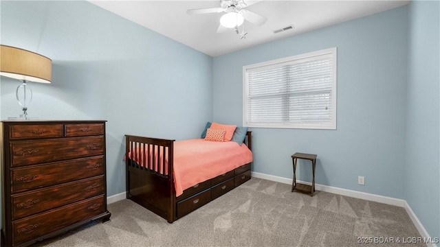 carpeted bedroom featuring baseboards and a ceiling fan