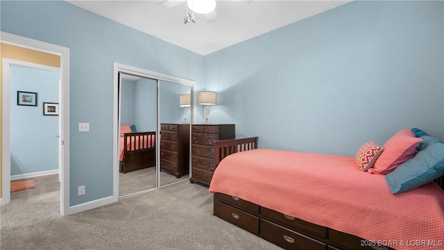 carpeted bedroom featuring a closet, baseboards, and ceiling fan