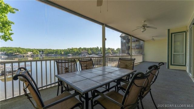 view of patio with ceiling fan, a water view, and outdoor dining space