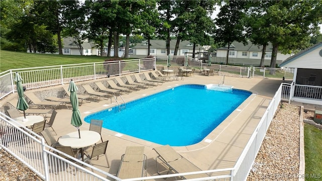 community pool featuring a patio and fence