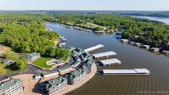 bird's eye view of a nearby body of water and a heavily wooded area