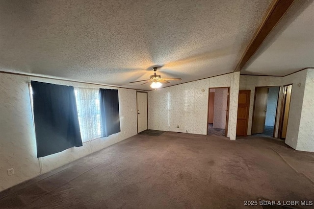 20877 Twin Hills Dr, Warsaw, MO 65355 - unfurnished room with a ceiling fan, vaulted ceiling, dark colored carpet, a textured wall, and a textured ceiling
