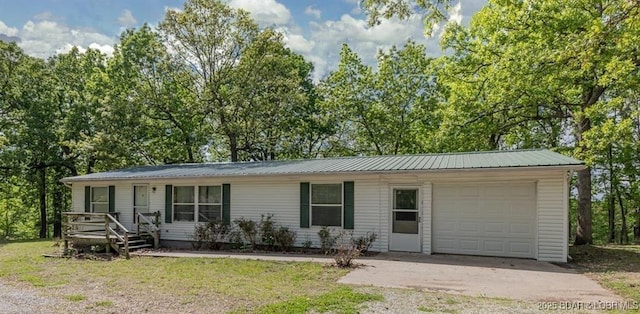 20877 Twin Hills Dr, Warsaw, MO 65355 - ranch-style home with a garage, driveway, metal roof, covered porch, and a front yard
