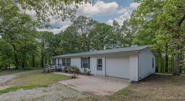 20877 Twin Hills Dr, Warsaw, MO 65355 - view of front of house with concrete driveway, metal roof, and an attached garage