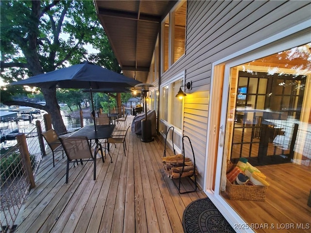 wooden terrace featuring outdoor dining area