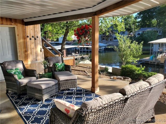 view of patio / terrace with a water view and an outdoor living space
