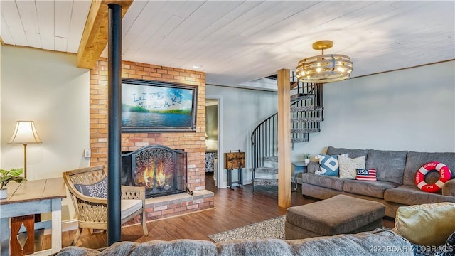living room featuring stairs, wooden ceiling, wood finished floors, and a fireplace