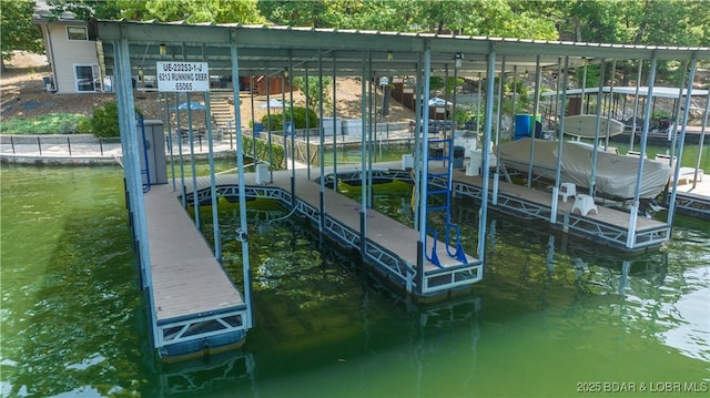 dock area with a water view and boat lift