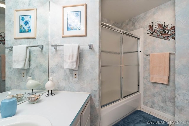 214 Emerald Bay Dr Unit 1D, Lake Ozark, MO 65049 - bathroom with tile patterned flooring, vanity, bath / shower combo with glass door, and wallpapered walls