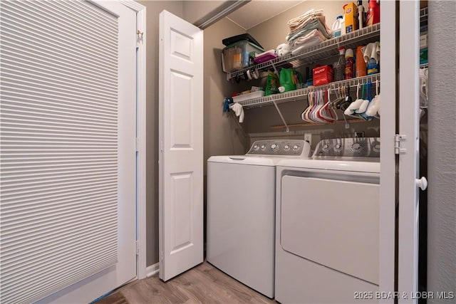 214 Emerald Bay Dr Unit 1D, Lake Ozark, MO 65049 - laundry room with separate washer and dryer and light wood-type flooring