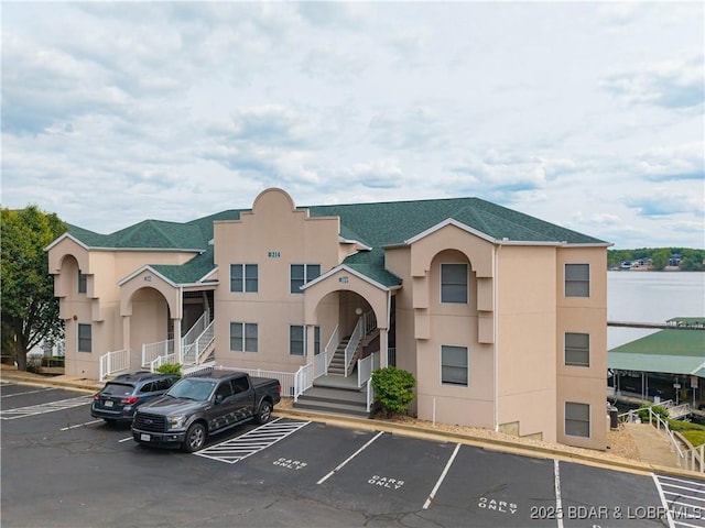 214 Emerald Bay Dr Unit 1D, Lake Ozark, MO 65049 - view of building exterior with uncovered parking and stairs