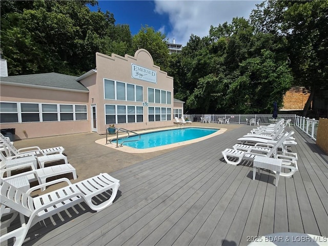 214 Emerald Bay Dr Unit 1D, Lake Ozark, MO 65049 - community pool featuring a wooden deck and a patio