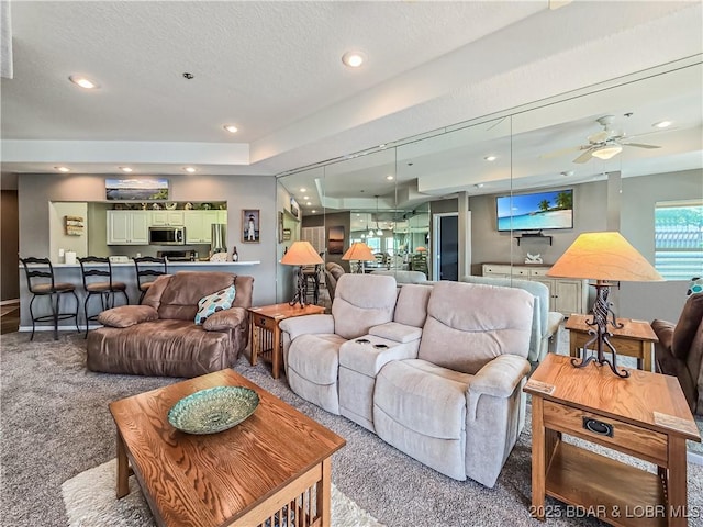 214 Emerald Bay Dr Unit 1D, Lake Ozark, MO 65049 - carpeted living room with recessed lighting, a textured ceiling, and a ceiling fan