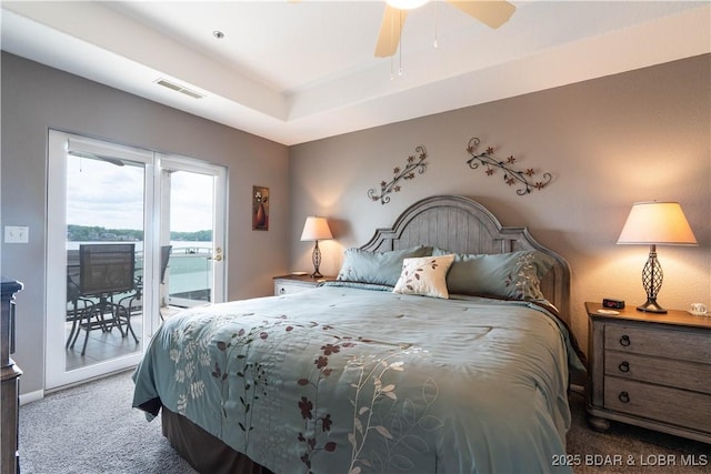214 Emerald Bay Dr Unit 1D, Lake Ozark, MO 65049 - carpeted bedroom with access to exterior, a tray ceiling, and ceiling fan