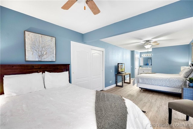 bedroom with wood finished floors, baseboards, ceiling fan, and a closet
