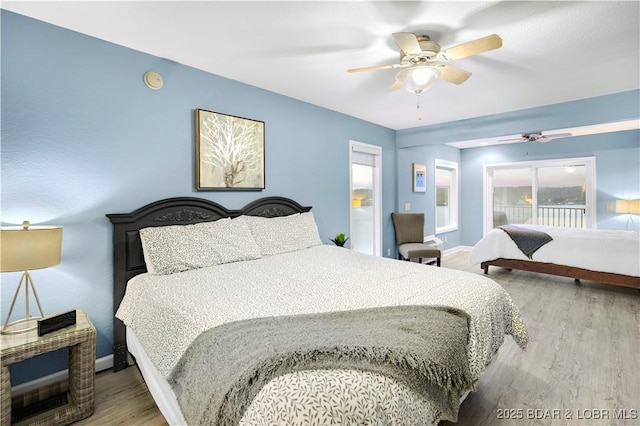 bedroom featuring wood finished floors, baseboards, and ceiling fan