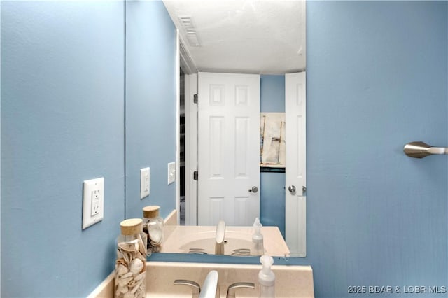 bathroom featuring a sink and baseboards