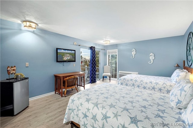 bedroom featuring wood finished floors, stainless steel refrigerator, baseboards, access to outside, and radiator heating unit