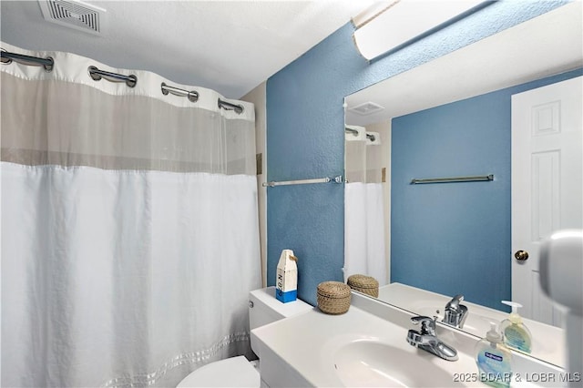 full bathroom featuring a textured wall, toilet, vanity, and a shower with curtain