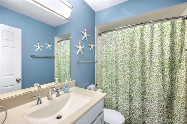 full bathroom with toilet and vanity