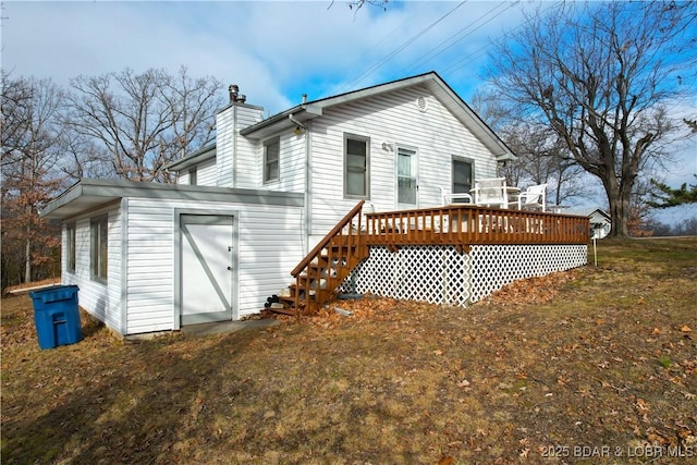 back of house featuring a deck, a chimney, and stairs