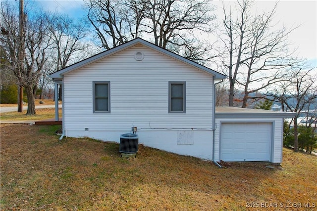 view of property exterior with crawl space, central AC unit, a lawn, and a garage