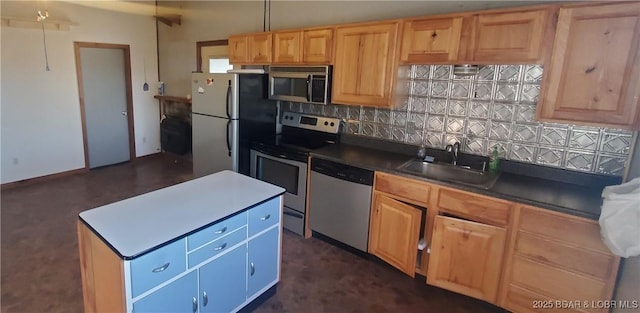 kitchen featuring appliances with stainless steel finishes, a sink, backsplash, dark countertops, and light brown cabinetry