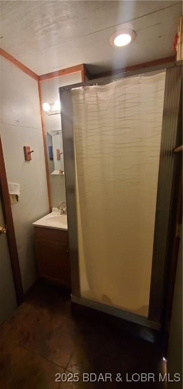 bathroom with vanity and a shower