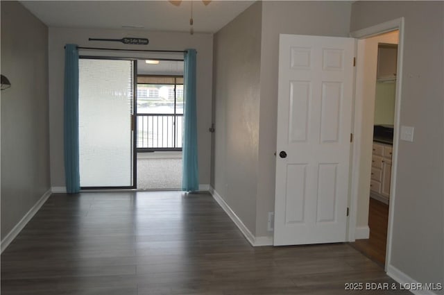 spare room with wood finished floors and baseboards