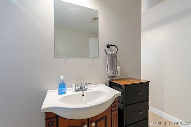 bathroom with tile patterned floors, vanity, and baseboards